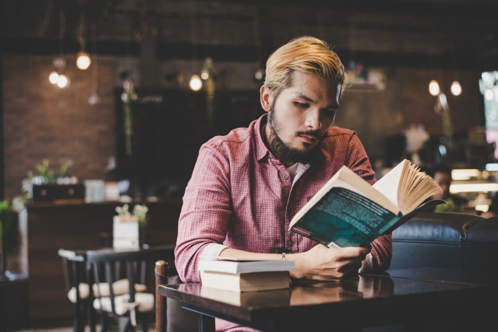 young bearded hipster reading a book in a cafe free photo 1024x683 - Ne'er Duke Well by Alexandra Vasti